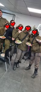 Soldiers eating bbq prepared by volunteers